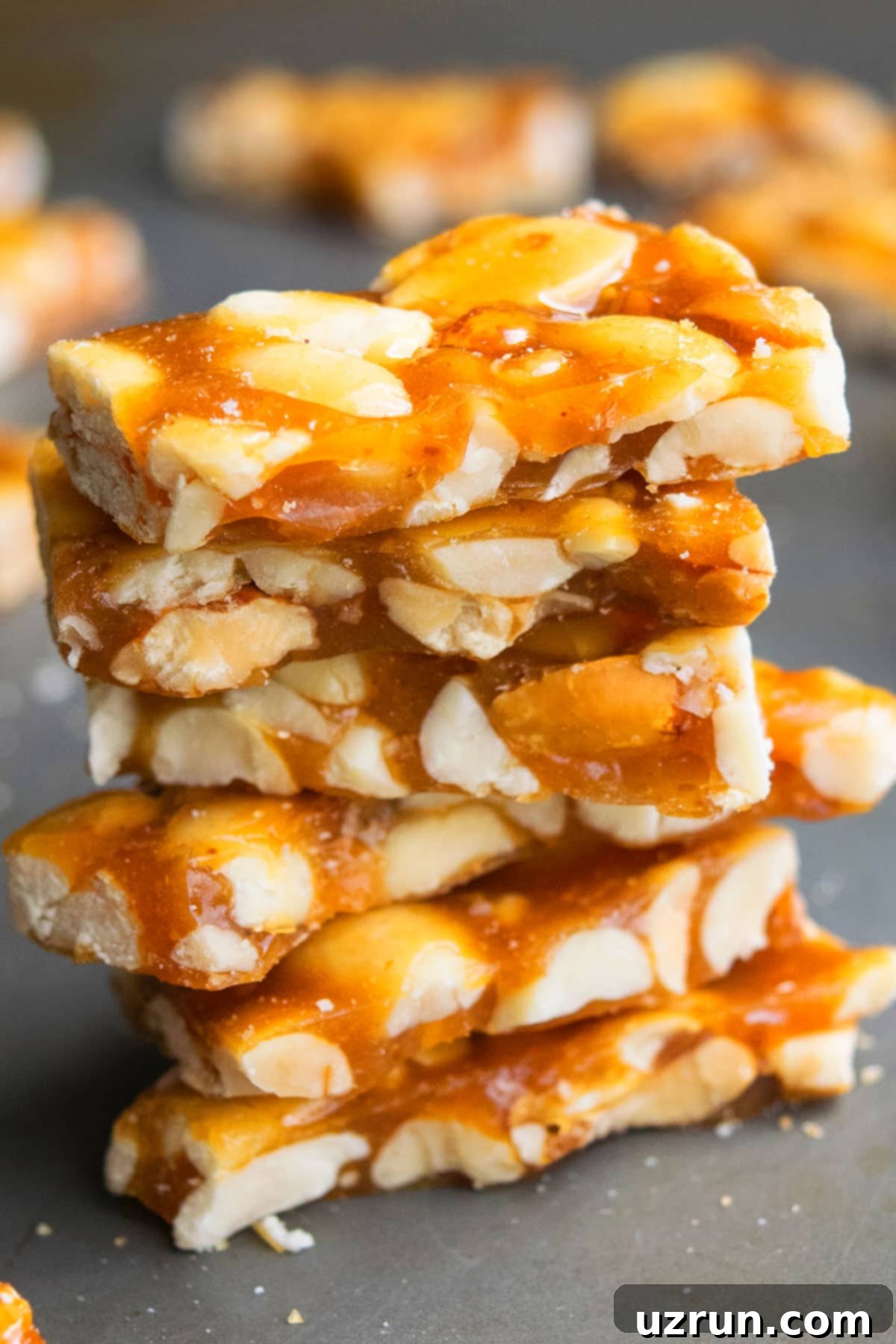Easy Microwave Peanut Brittle 3 Stack of Homemade Brittle on Metal Tray.