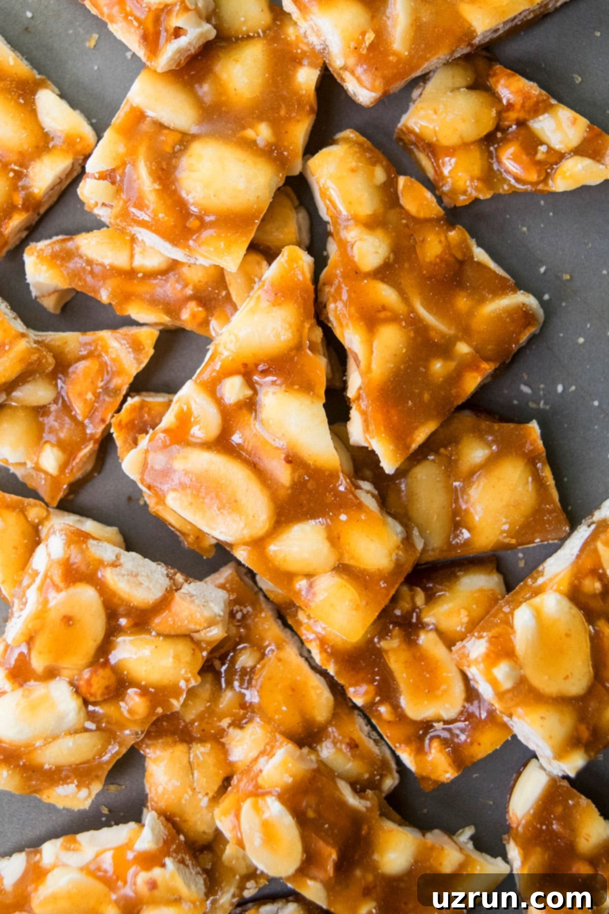 Easy Microwave Peanut Brittle 4 Broken Shards of Hard Peanut Candy on Metal Tray.