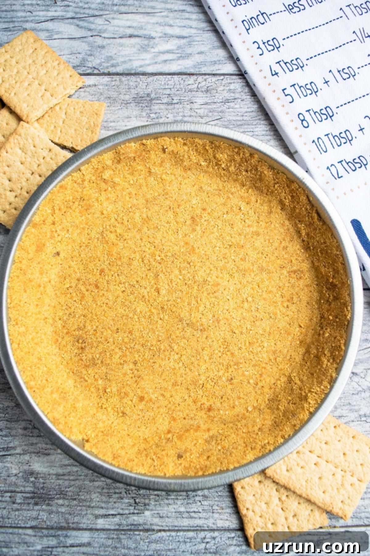 Easy Homemade Graham Cracker Crust on Rustic Gray Background.