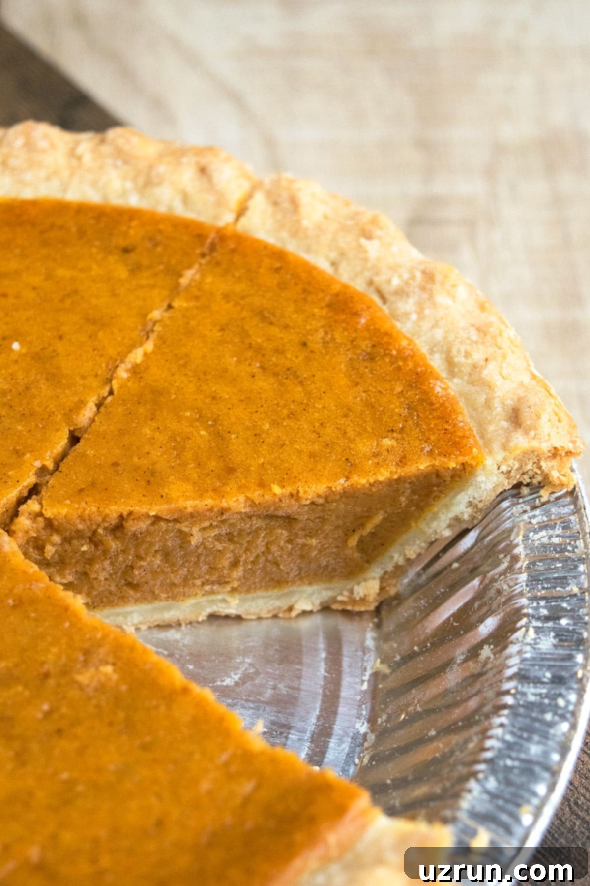 Easy 5 Ingredient Pumpkin Pie 3 Classic Homemade Pumpkin Pie From Scratch With One Slice Removed in Foil Tray.