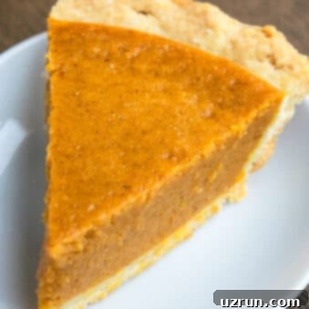 Easy 5 Ingredient Pumpkin Pie 6 Easy Pumpkin Pie With Flaky Butter Pie Crust on White Dish.