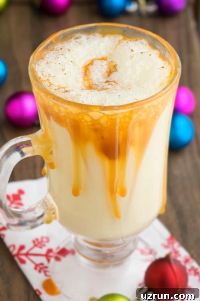 Simple and Creamy Homemade Eggnog 3 Christmas Holiday Nog with Caramel Sauce in Glass Mug. A festive drink for the holidays.