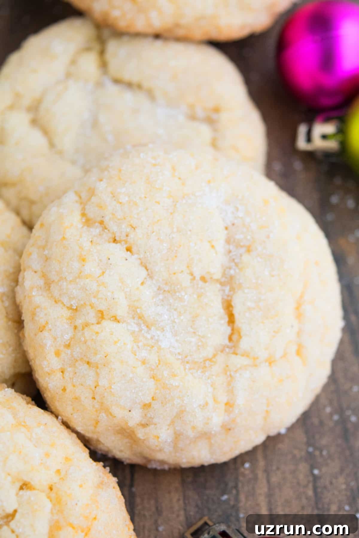 Easy Eggnog Cookies With Cake Mix on Wood Background- Closeup Shot. A close-up of a plate of golden brown eggnog cookies, highlighting their soft texture and festive appeal.