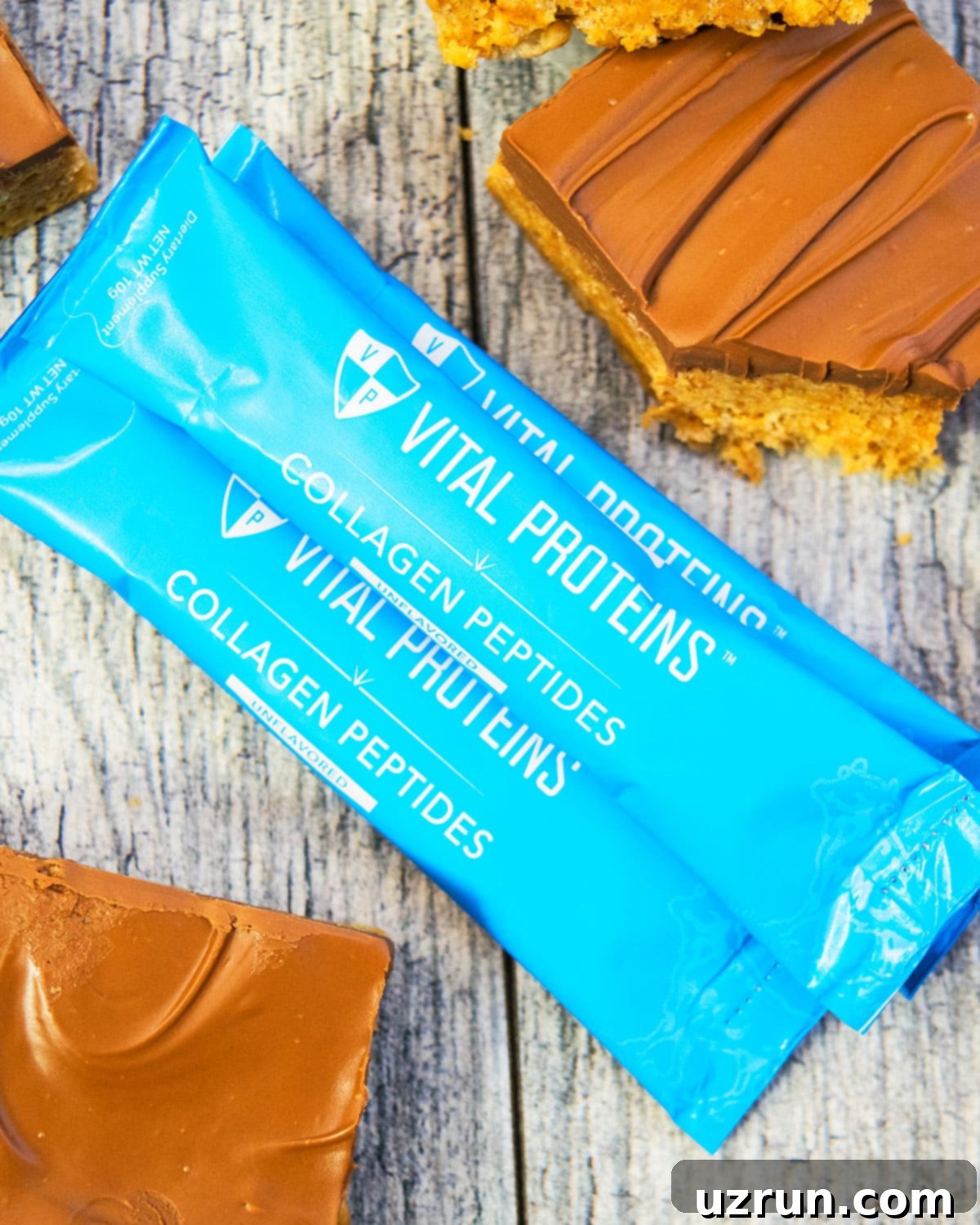 Easy Scotcheroos Without Corn Syrup 7 Packets of Vital Proteins Collagen on Rustic Gray Background.