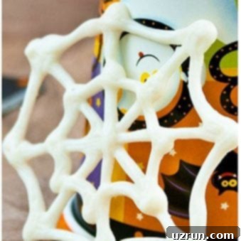 Simple Chocolate Spiderweb Cupcakes 5 Easy Spider Web Cupcakes Toppers With Seasonal Decor in Background
