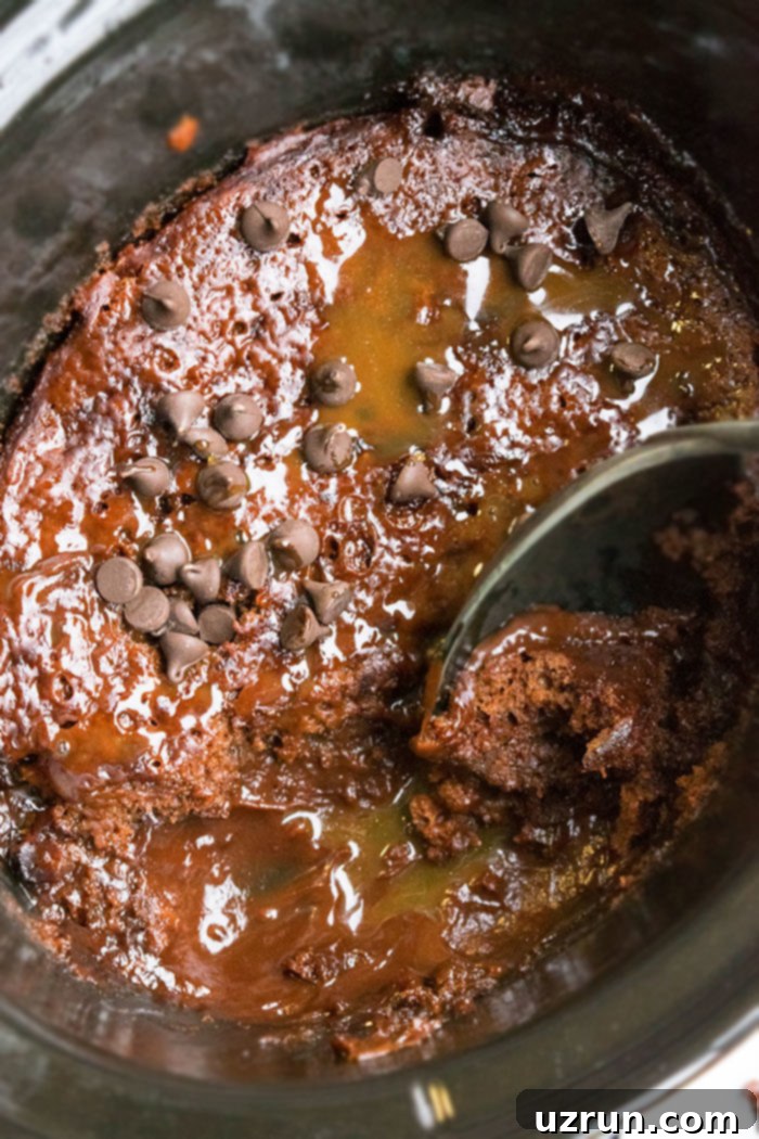 Easy Box Mix Slow Cooker Chocolate Lava Cake 3 Closeup Shot of Slow Cooker Cake With One Spoonful Removed, showing the gooey molten chocolate center.