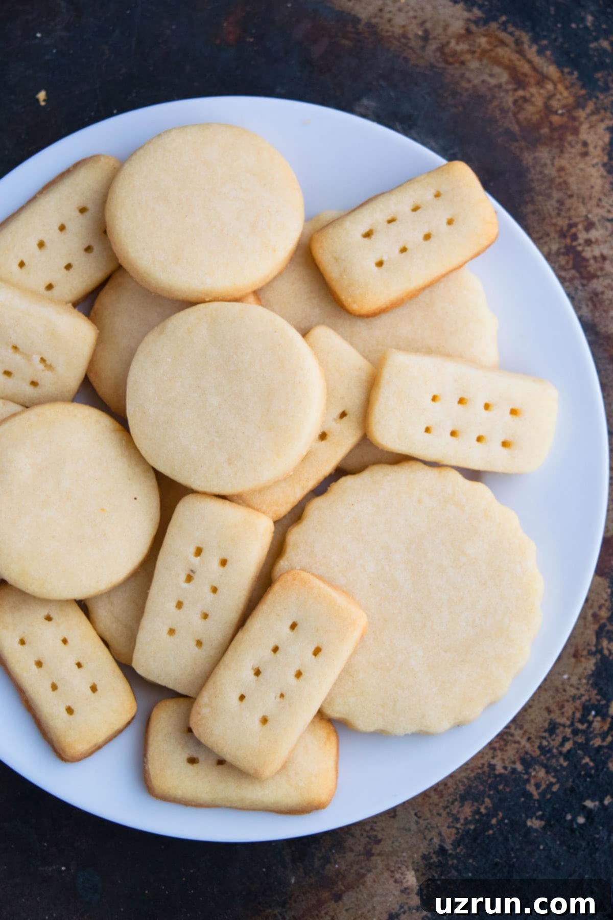 Best 3-Ingredient Shortbread Cookies 4 Christmas Whipped Cut Out Cookies on White Dish.