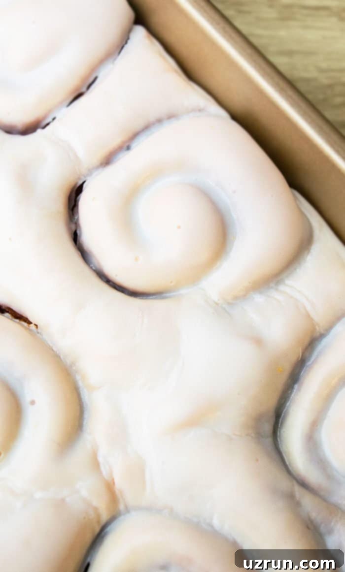 Foolproof One-Hour Homemade Cinnamon Buns 2 Closeup Shot of Cinnamon Roll Frosting or Icing- Overhead Shot.