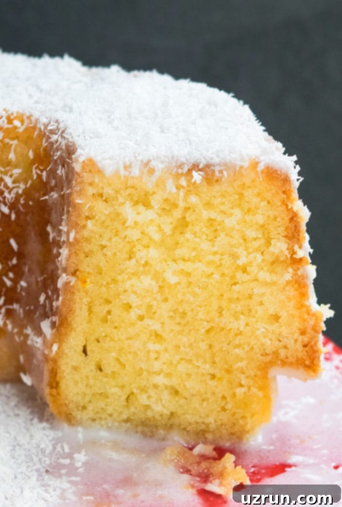 Easy Louisiana Crunch Cake 4 Best Coconut Crunch Cake on Red Dish With One Slice Removed