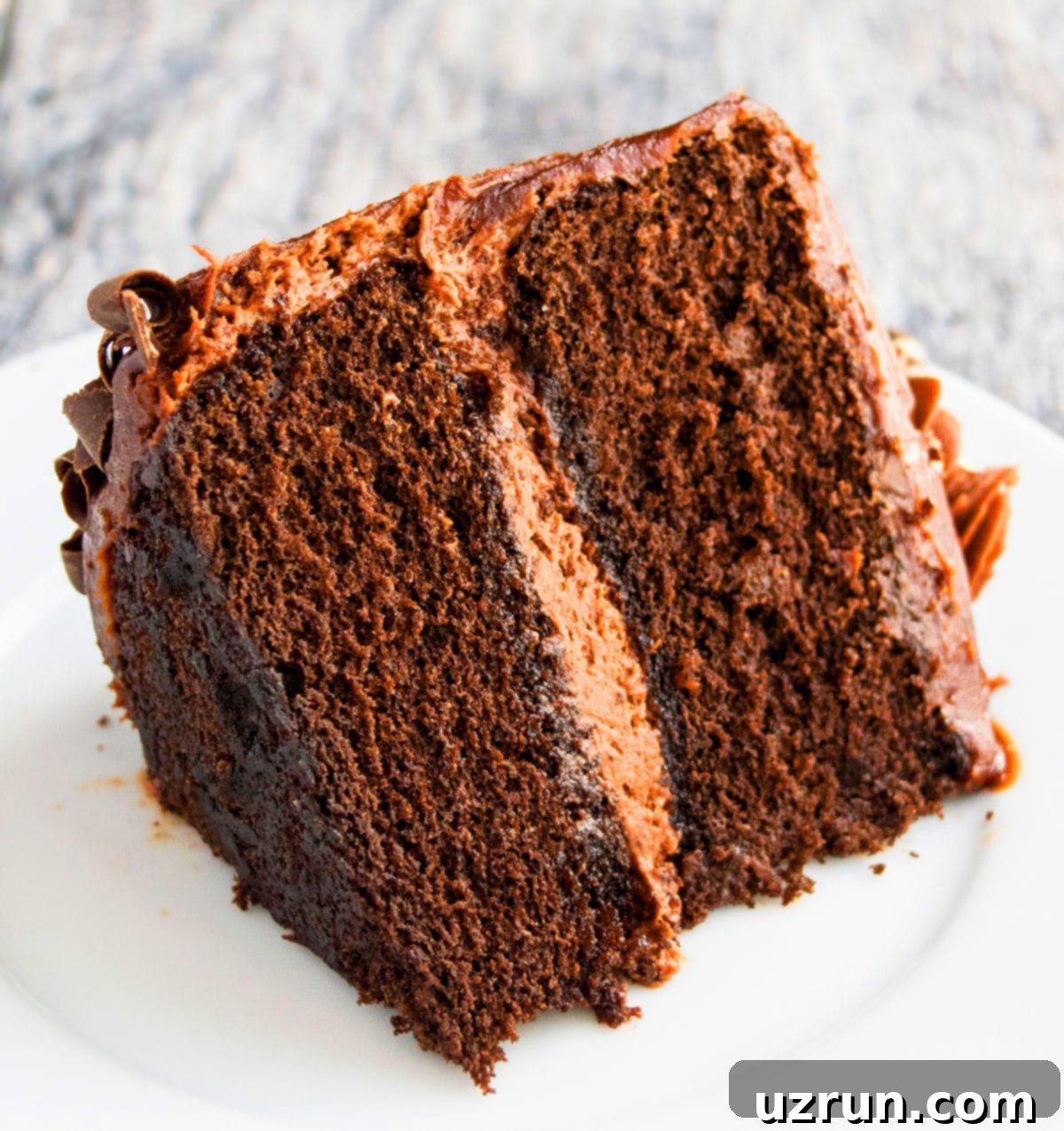Decadent Chocolate Guinness Cake Made Easy 4 Slice of Frosted Cake on White Dish.