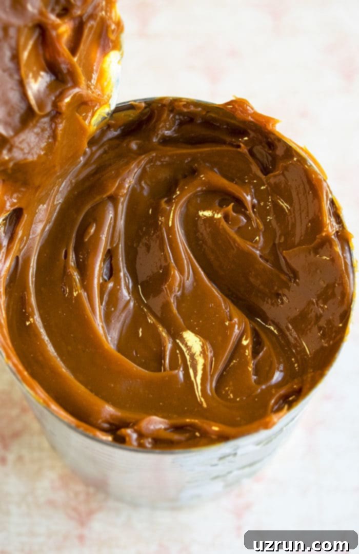 Mastering Homemade Dulce De Leche 4 Can of Caramelized Sweetened Condensed Milk on Marble Background.