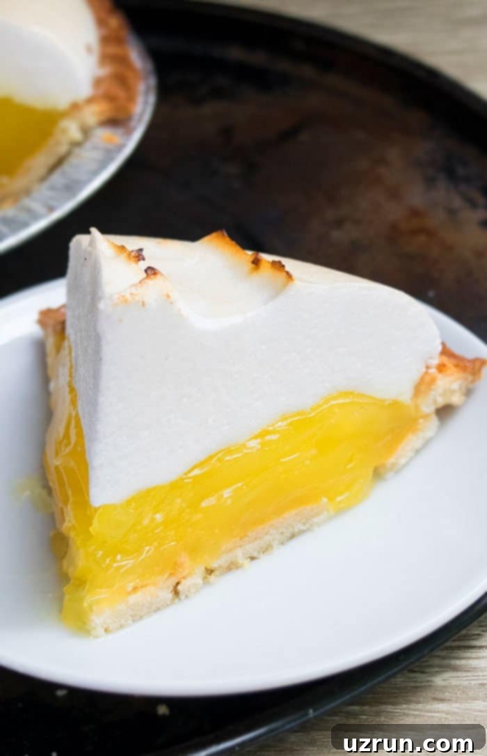 Lemon Meringue Pie That Never Weeps 3 Slice of Meringue Pie on White Dish.