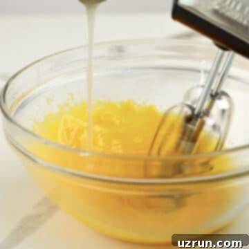 Lemon Meringue Pie That Never Weeps 5 Egg yolks being tempered in glass bowl.