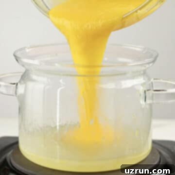 Lemon Meringue Pie That Never Weeps 6 Tempered egg yolks being added to lemon mixture.