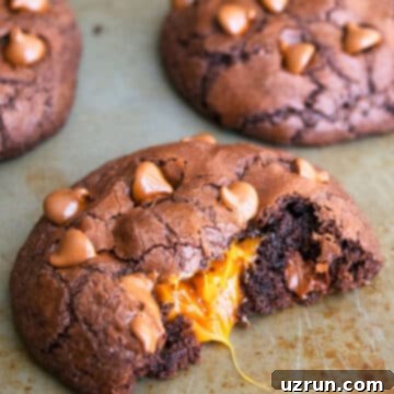 Stuffed Chocolate Caramel Cookies 5 Easy Chocolate Caramel Cookies With Filling Oozing Out on Baking Tray.