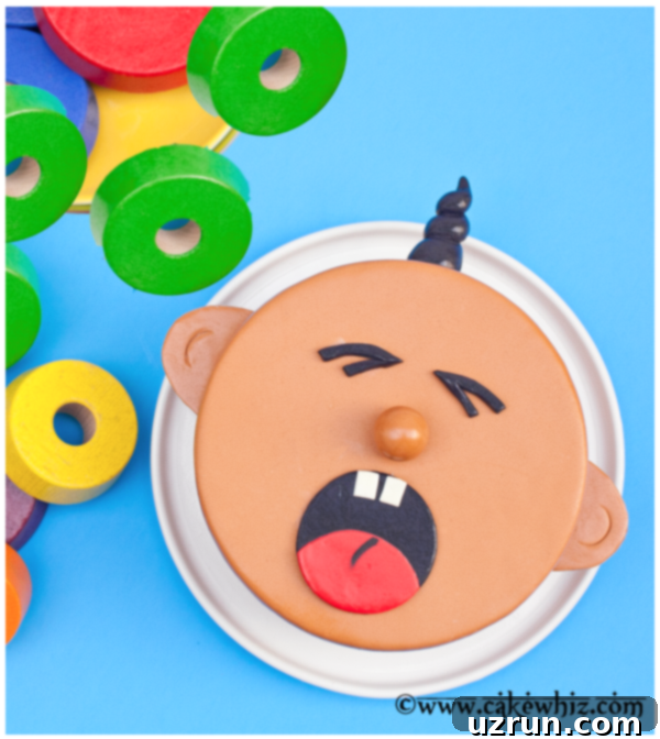 crying baby cake front view, showing the detailed fondant face with tears and open mouth