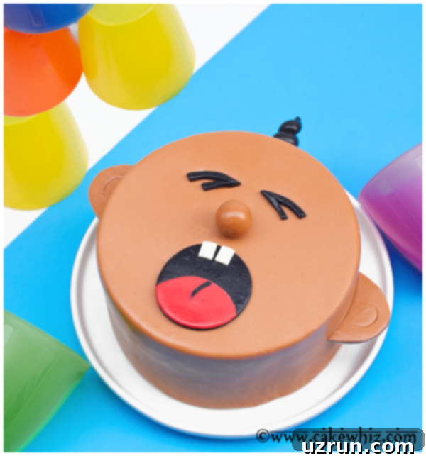A Cry for Cake 4 crying baby cake side view with black fondant hair and brown fondant ear details