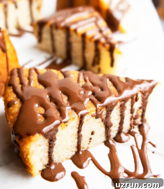 Effortless Homemade Honey Cake 4 Slice of Homemade Cake With Chocolate Glaze on Marble Background.