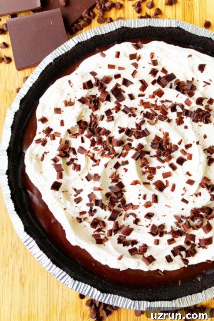 Easy No Bake Chocolate Cream Pie With Oreo Crust on Wood Background