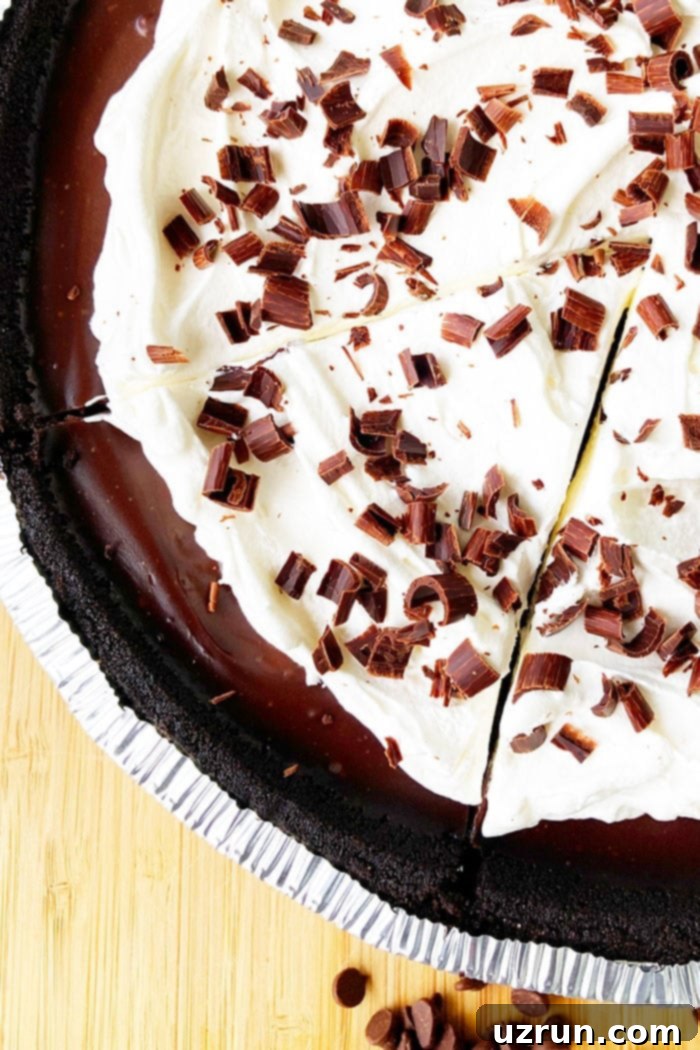 Easy No-Bake Chocolate Cream Pie 5 No Bake Chocolate Pie With Whipped Cream and Chocolate Shavings on Wood Background- Overhead Shot