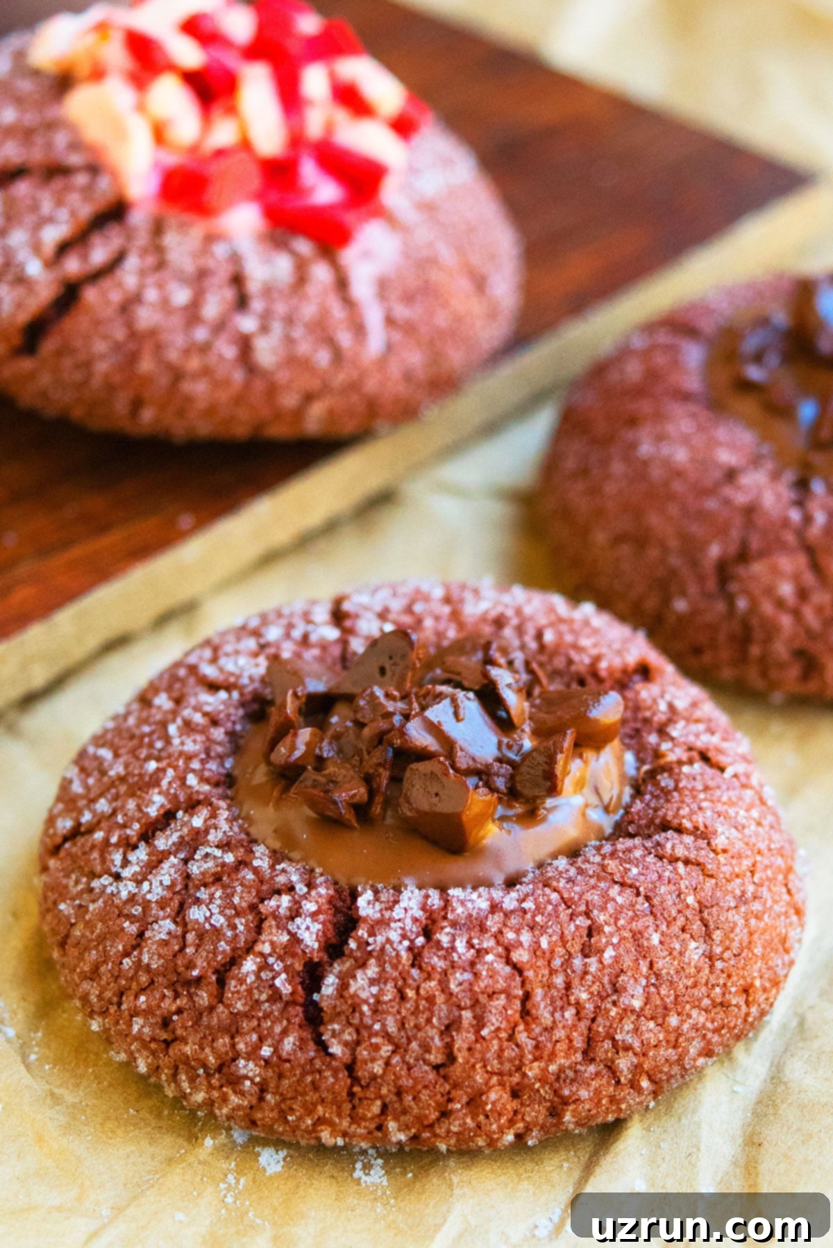 Ganache-Filled Chocolate Thumbprint Cookies 4 Closeup shot of a Classic Chocolate Thumbprint Cookie on Parchment Paper, highlighting the perfect indentation.