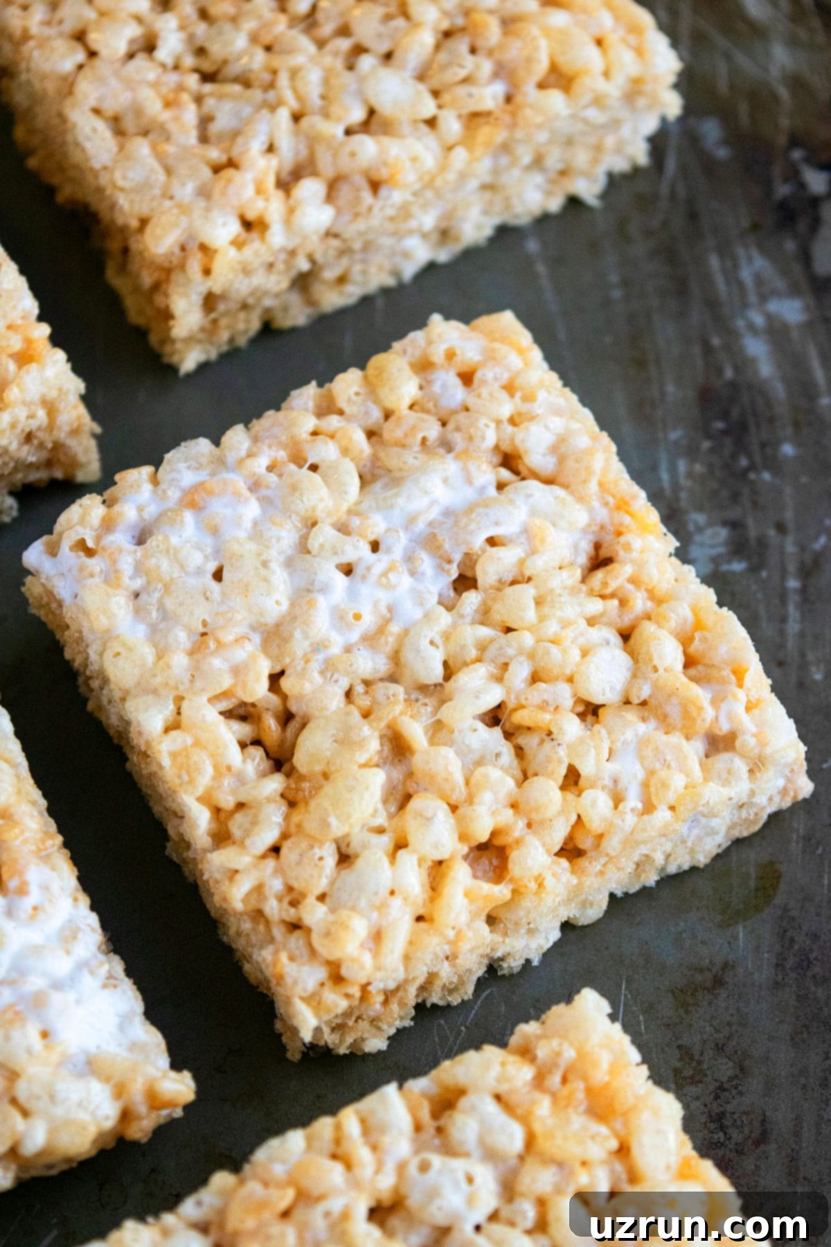 Slice of Best Easy Homemade Rice Krispie Treats on Gray Tray. 