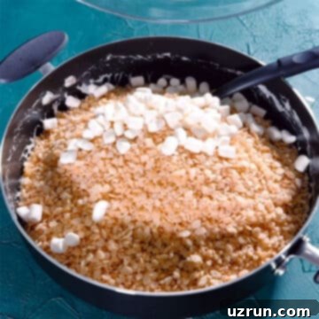 The Ultimate Guide to Perfect Rice Krispie Treats 8 Rice krispies cereal and mini marshmallows added to nonstick pot.