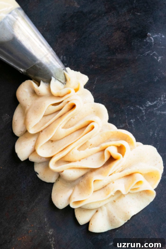 Easy Maple Frosting Piped on Black Background