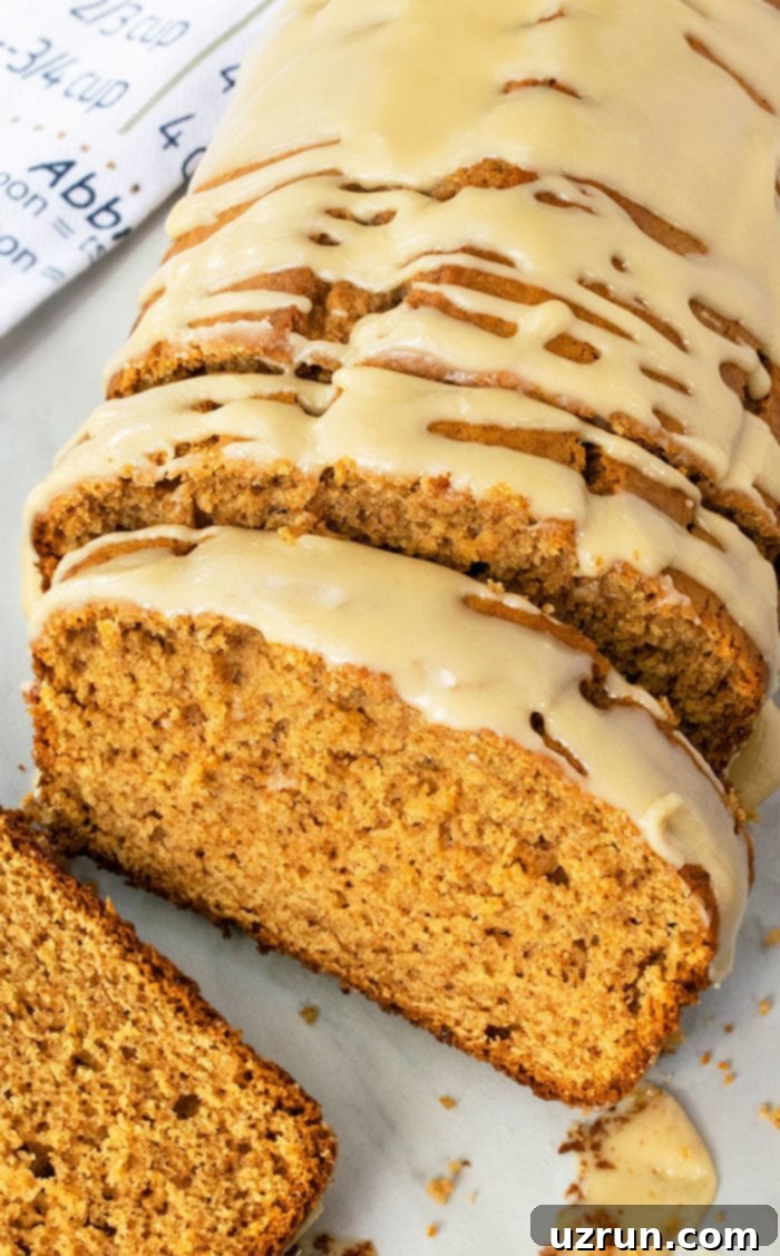 Simple Cake Mix Pumpkin Bread 3 Partially Sliced Bread With Maple Glaze- Overhead Shot.