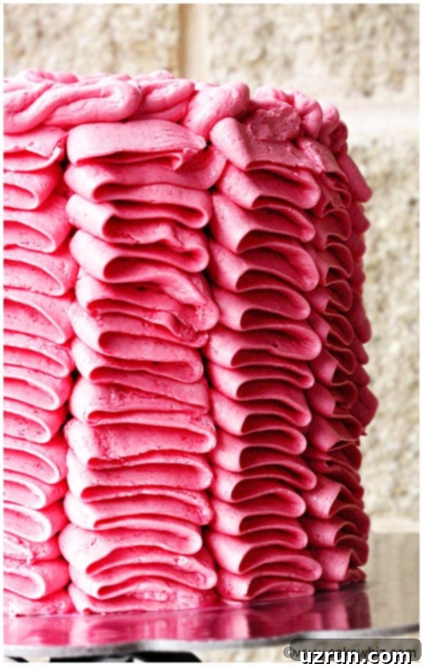 Closeup Shot of Pink Buttercream Ruffle Cake With Brick Background