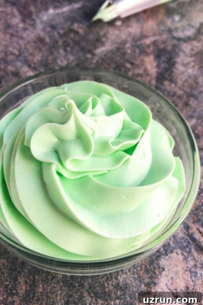 Quick Refreshing Mint Frosting 3 Homemade Mint Buttercream Frosting on a cooling rack, showcasing its creamy texture.