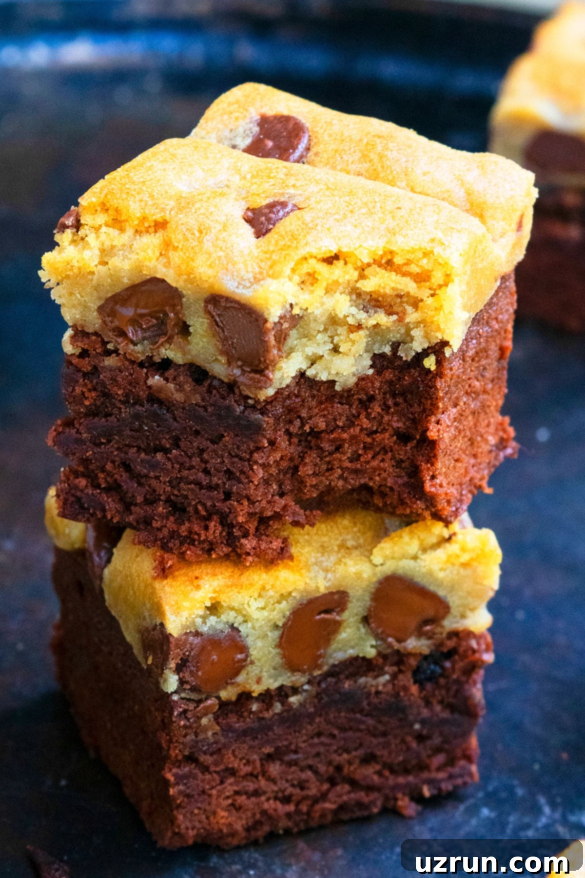 Stack of Easy Brookies Recipe (Brownie Cookie Hybrid) on Dark Metal Tray.