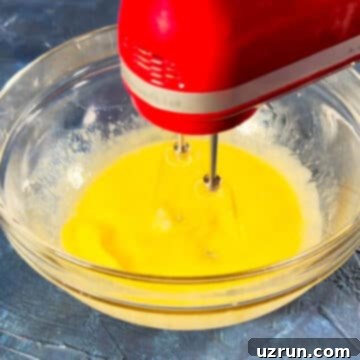 Easy Brookies with Brownie Mix 5 Eggs, oil and water being mixed with a hand-held mixer in a glass bowl.