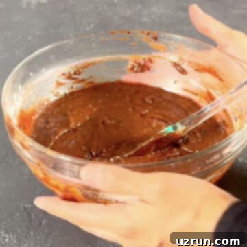 Easy Brookies with Brownie Mix 7 Brownie batter with spatula in glass bowl.