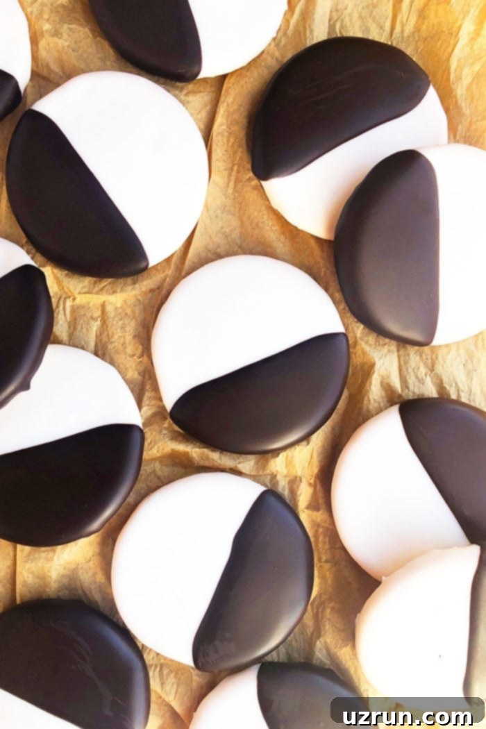 Ebony and Ivory Moon Cookies 5 Overhead shot of many delicious Black and White Cookies spread out on brown paper, showcasing a generous batch.
