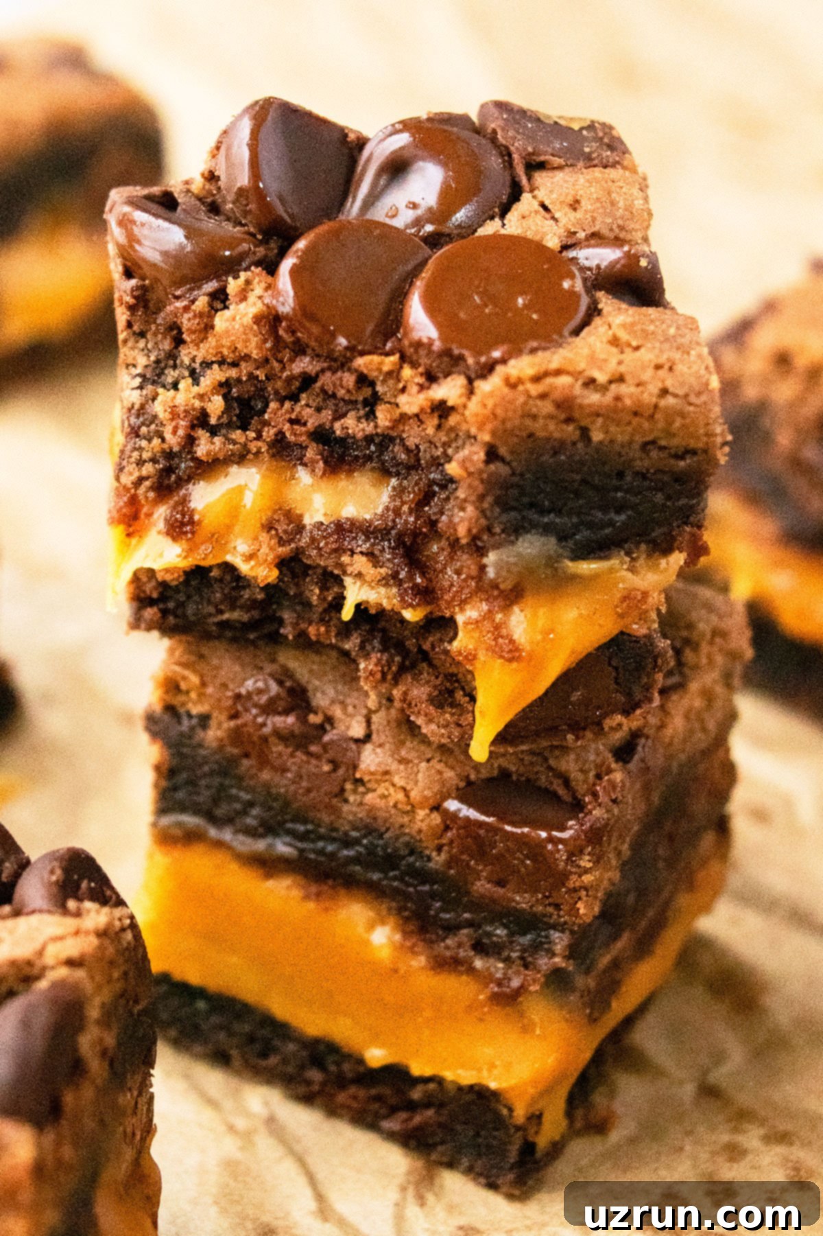 Stack of Easy Chocolate Caramel Brownies With Brownie Mix on Brown Parchment Paper. 