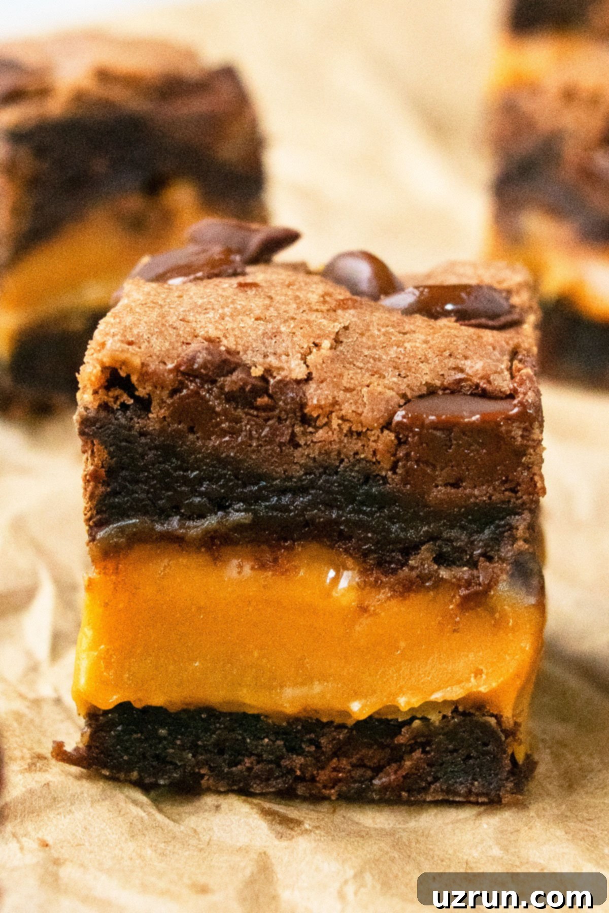 Box Mix Caramel Brownies 3 Slice of Fudgy Brownie on Brown Parchment Paper.