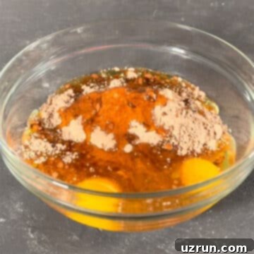 Box Mix Caramel Brownies 4 Brownie batter ingredients mixed in large glass bowl.