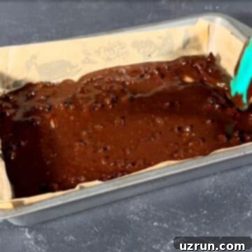 Box Mix Caramel Brownies 5 Brownie batter being spread evenly in a lined baking pan.