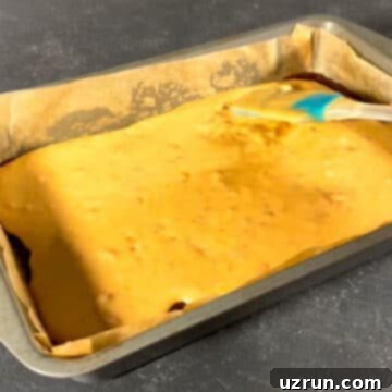 Box Mix Caramel Brownies 8 Caramel sauce being poured on top of chocolate batter.