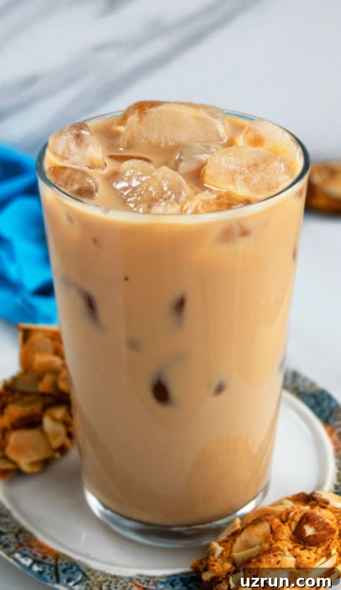 Iced Vanilla Latte in a Clear Glass on a Plate with Cookies