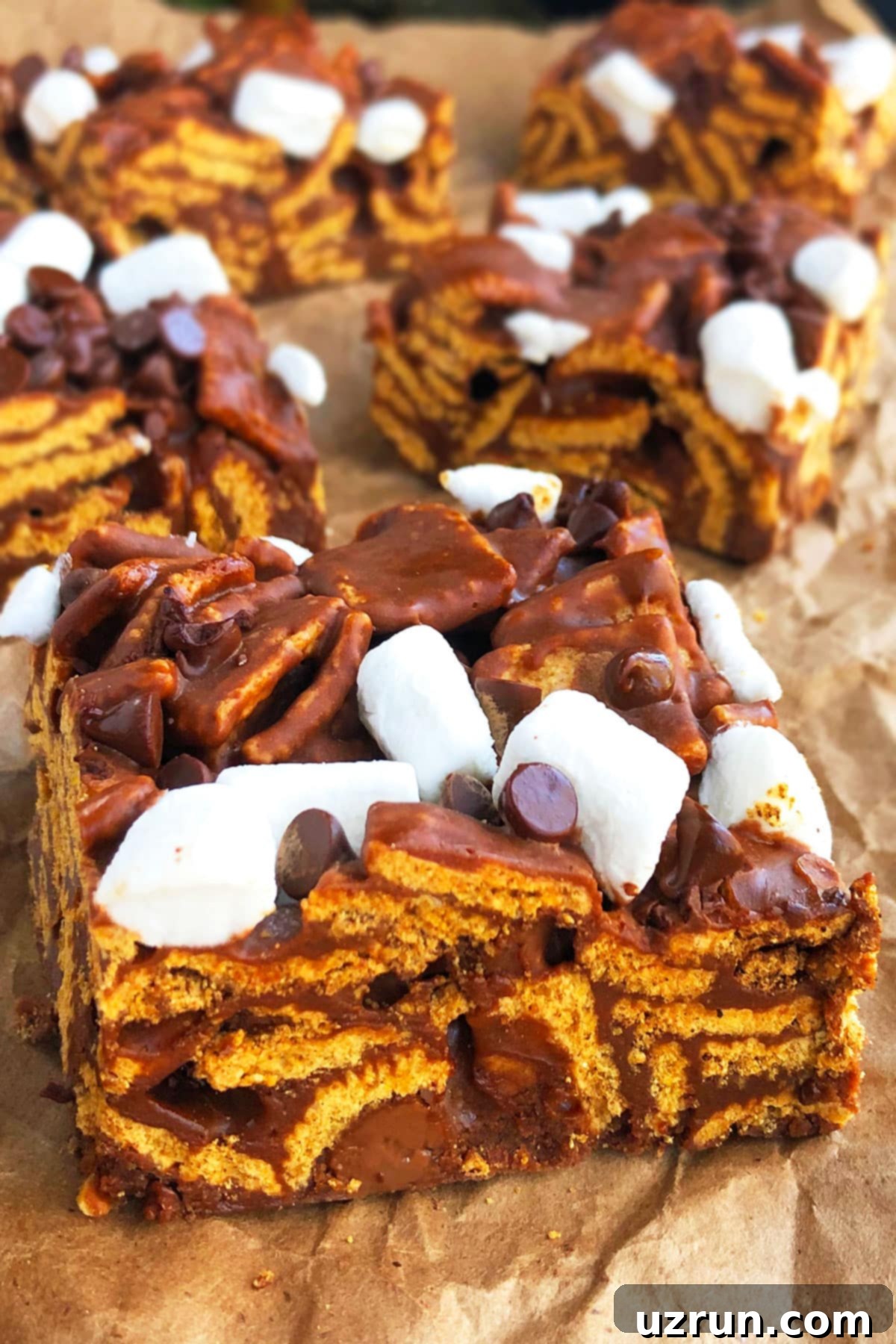 Easy No Bake Smores Bars 4 Slice of No Bake Chocolate Marshmallow Bars on Brown Parchment Paper.