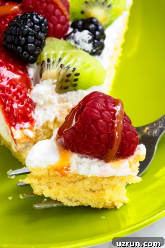 Effortless 30-Minute Fruit Pizza 4 Closeup Shot for a Bite of Dessert Pizza with Fruits on Green Plate