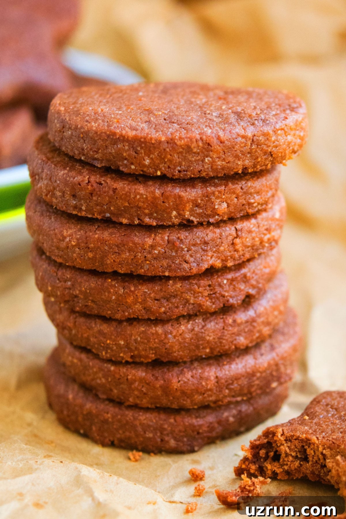 Stack of Easy Cut Out Chocolate Sugar Cookies on Sheet of Brown Parchment Paper. 