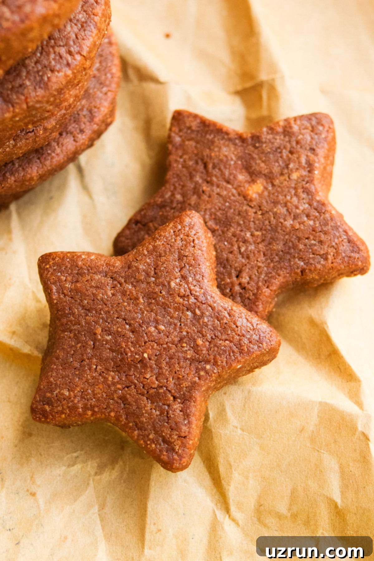 Easy Cut-Out Chocolate Sugar Cookies 3 Star Shaped Cut Out Chocolate Cookies on Brown Parchment Paper.