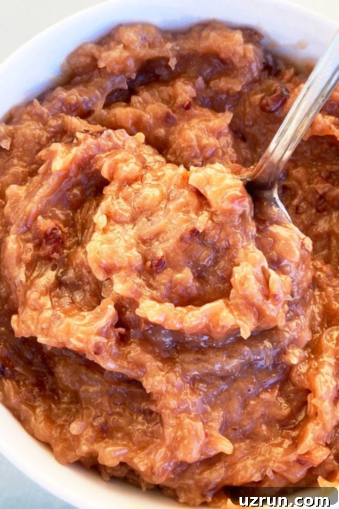Homemade Coconut Pecan Frosting in a White Bowl, showcasing its rich, chunky texture
