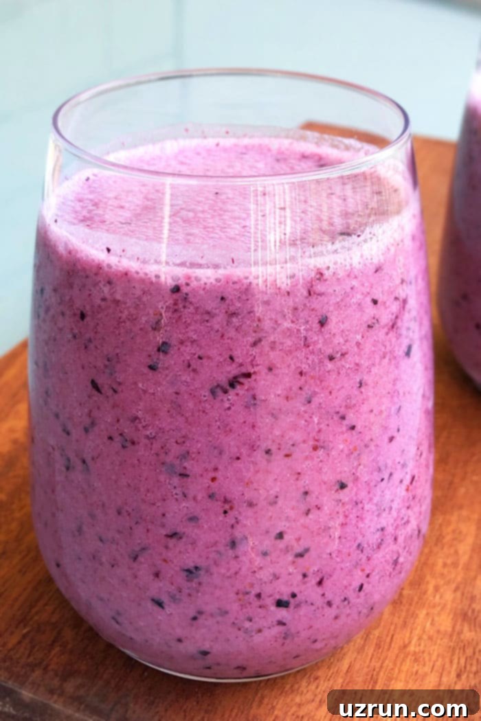 Velvet Blueberry Blend 2 Homemade Blueberry Smoothie in a Clear Cup Placed on a Wood Base