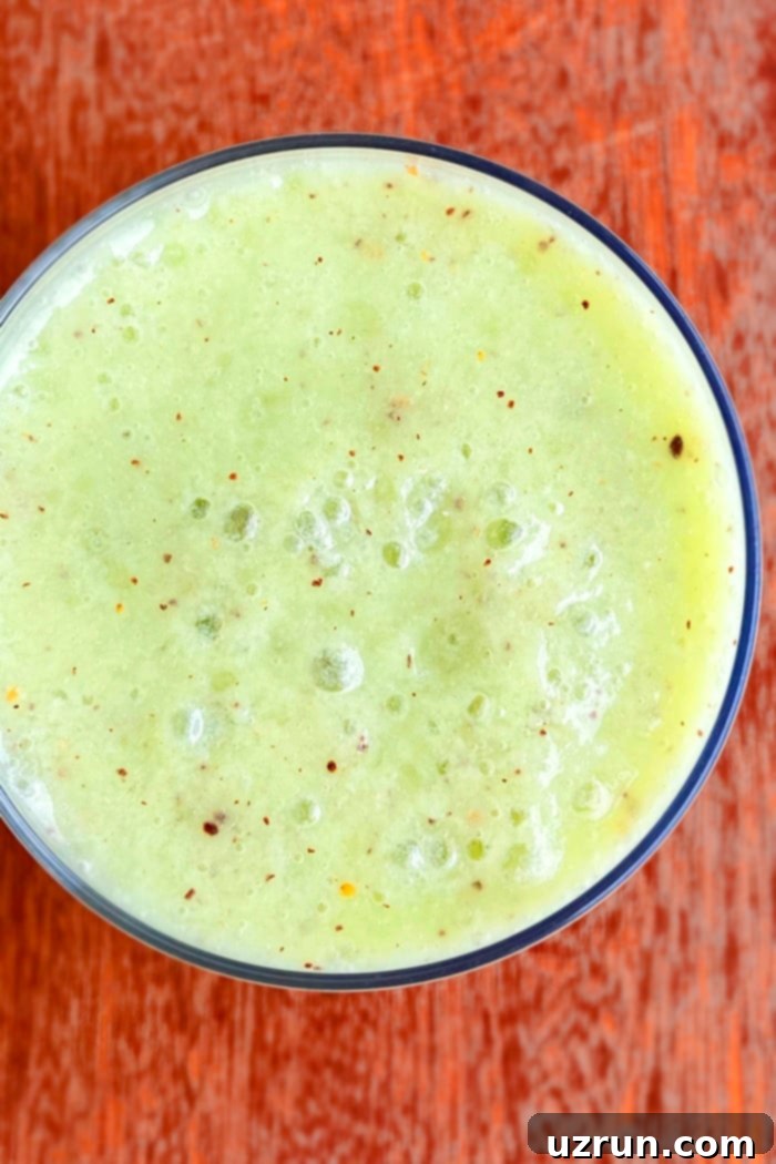 Vibrant Kiwi Power Smoothie 3 Overhead Close-up Shot of Easy Kiwi Banana Spinach Smoothie in a Clear Cup