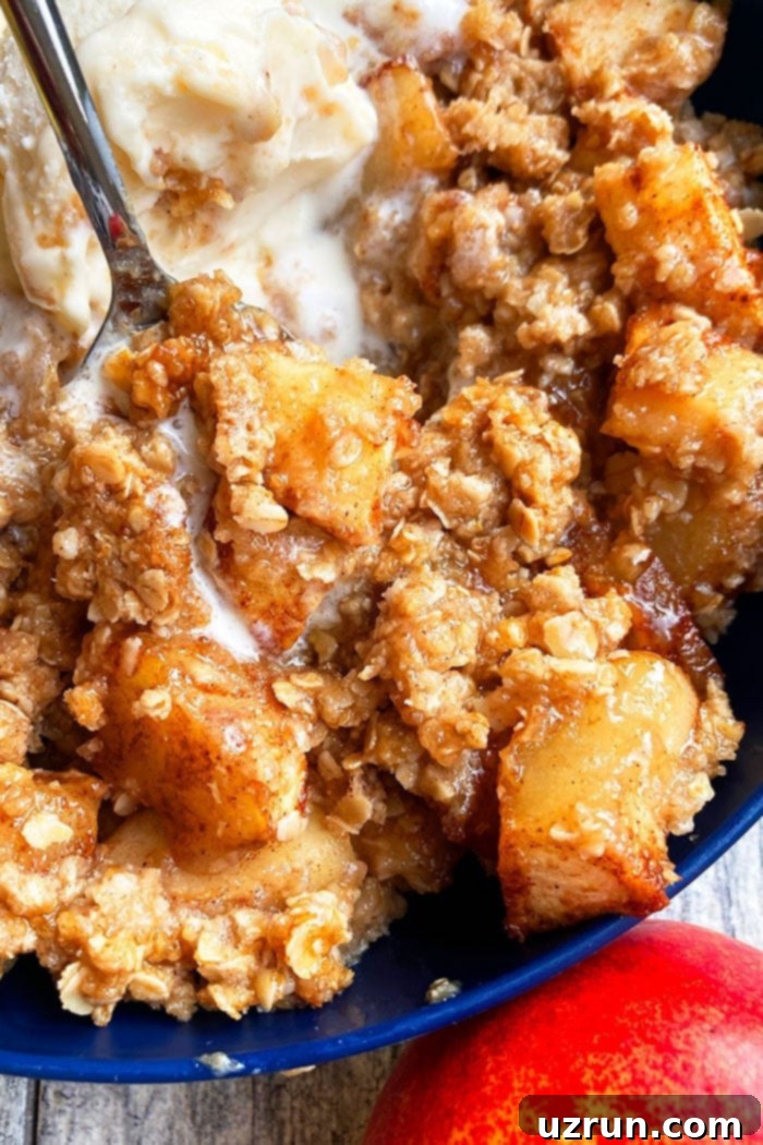 Closeup Shot of Easy Apple Cobbler with Vanilla Ice Cream and Caramel Sauce