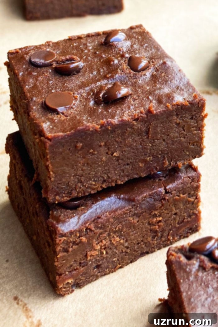 Stack of Two Fudgy Pumpkin Brownies Placed on Sheet of Brown Paper